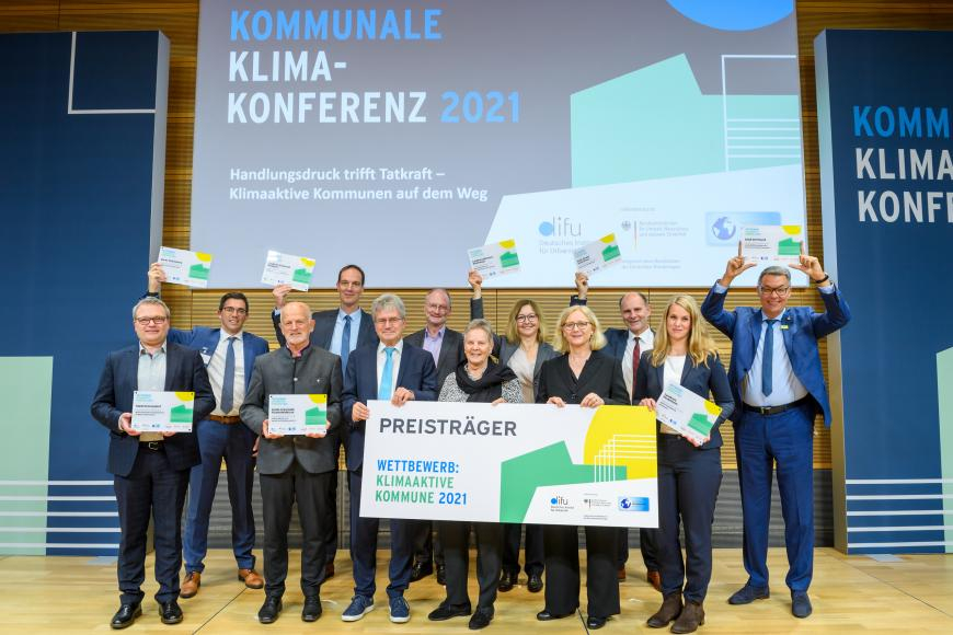 Preisträger des Wettbewerbs Klimaaktive Kommune 2021 auf dem Podium