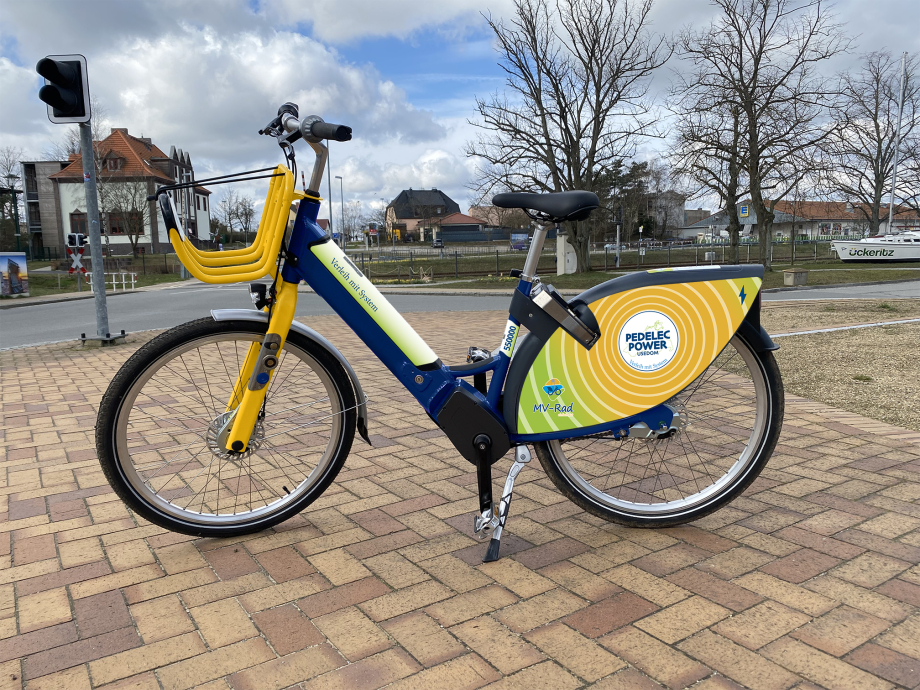 Ein E-Bike steht auf einer gepflasterten Fläche.