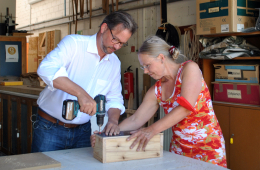 Das Bild zeigt Florian Pronold beim Verschrauben eines Pflanzkastens mit der Projektleiterin Ilka Holtorf.